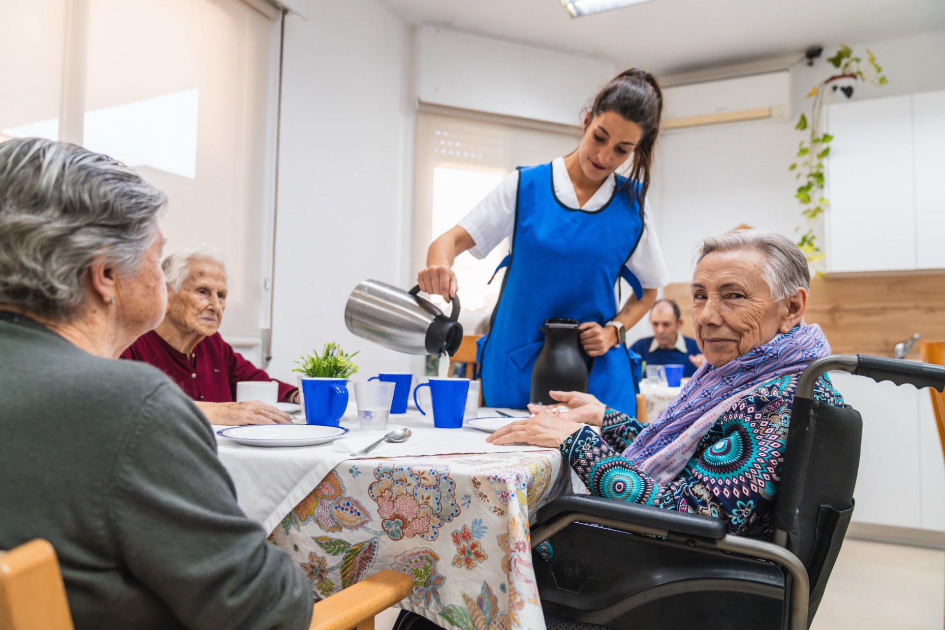 Caregiver supporting elderly woman